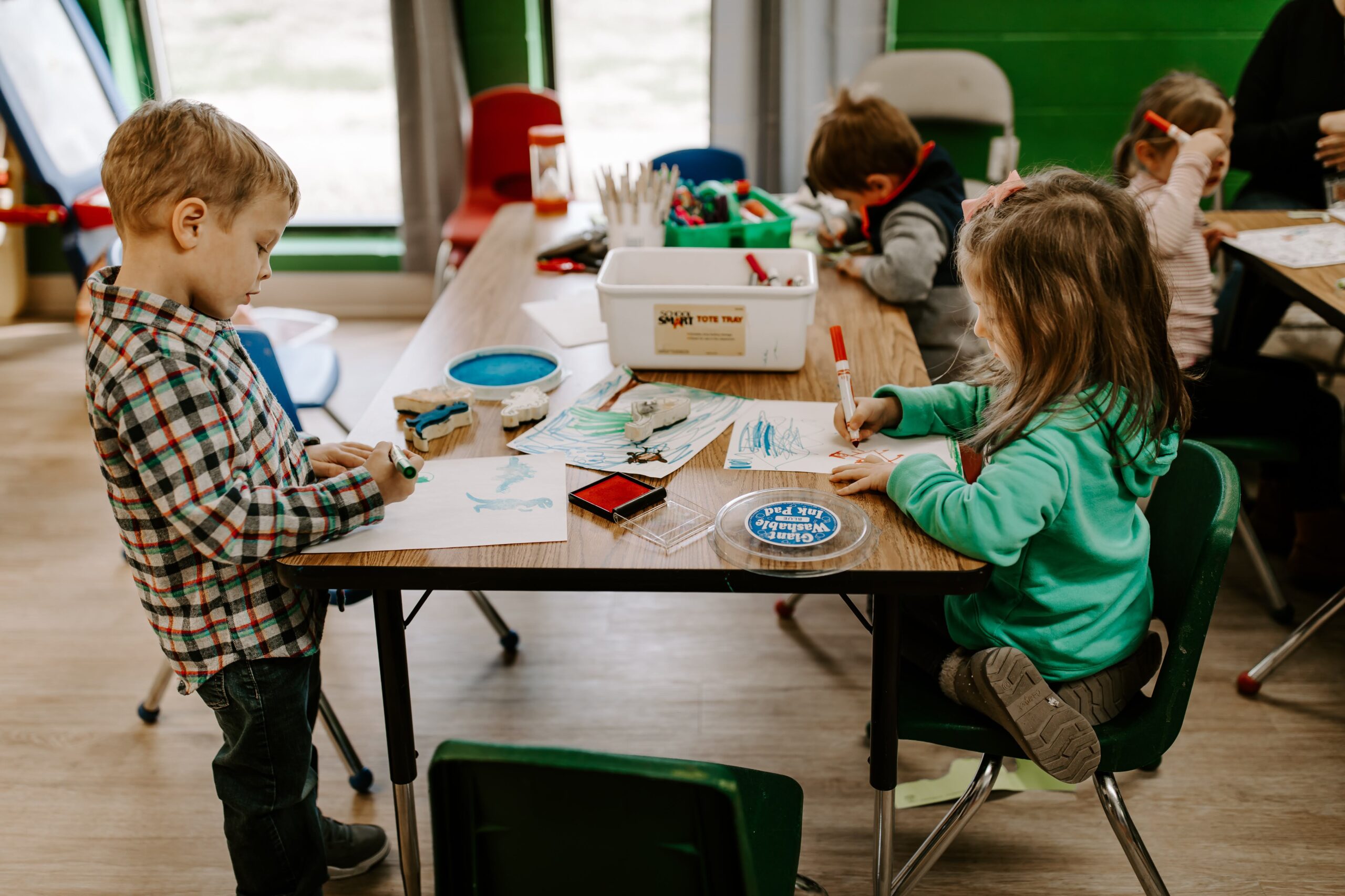 A preschool class coloring together