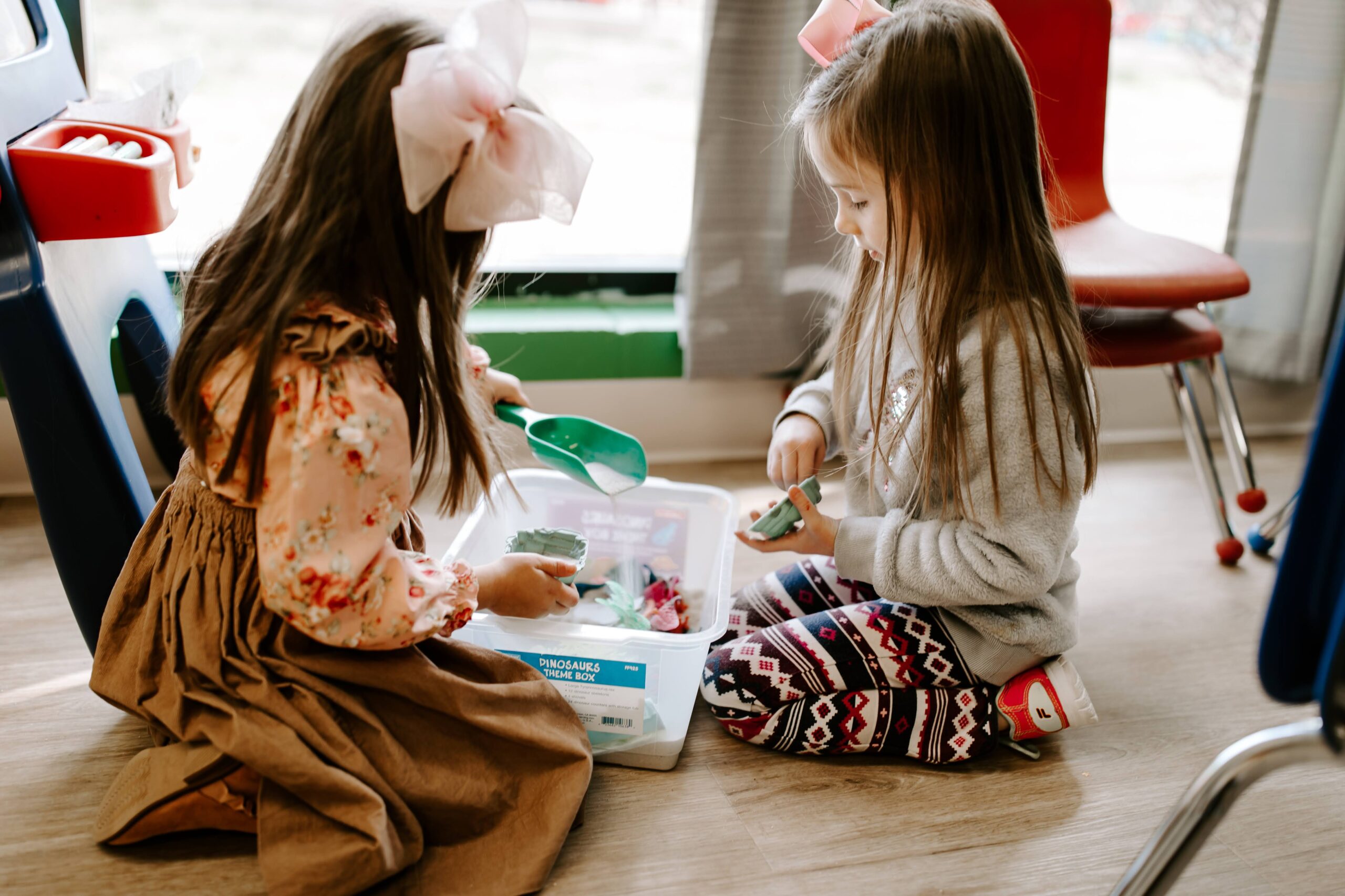 Two kids playing with kinetic sand