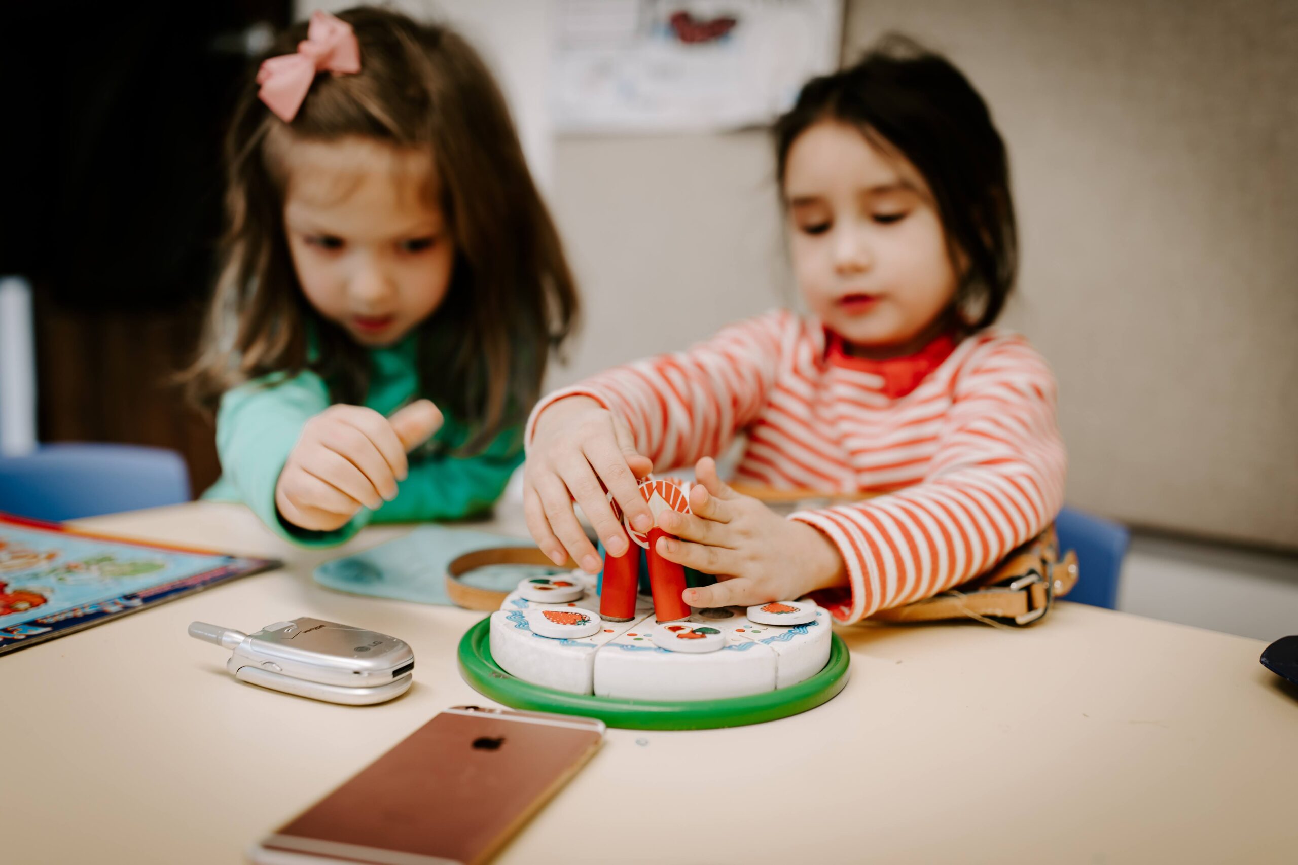 A girl playing with a cake toy