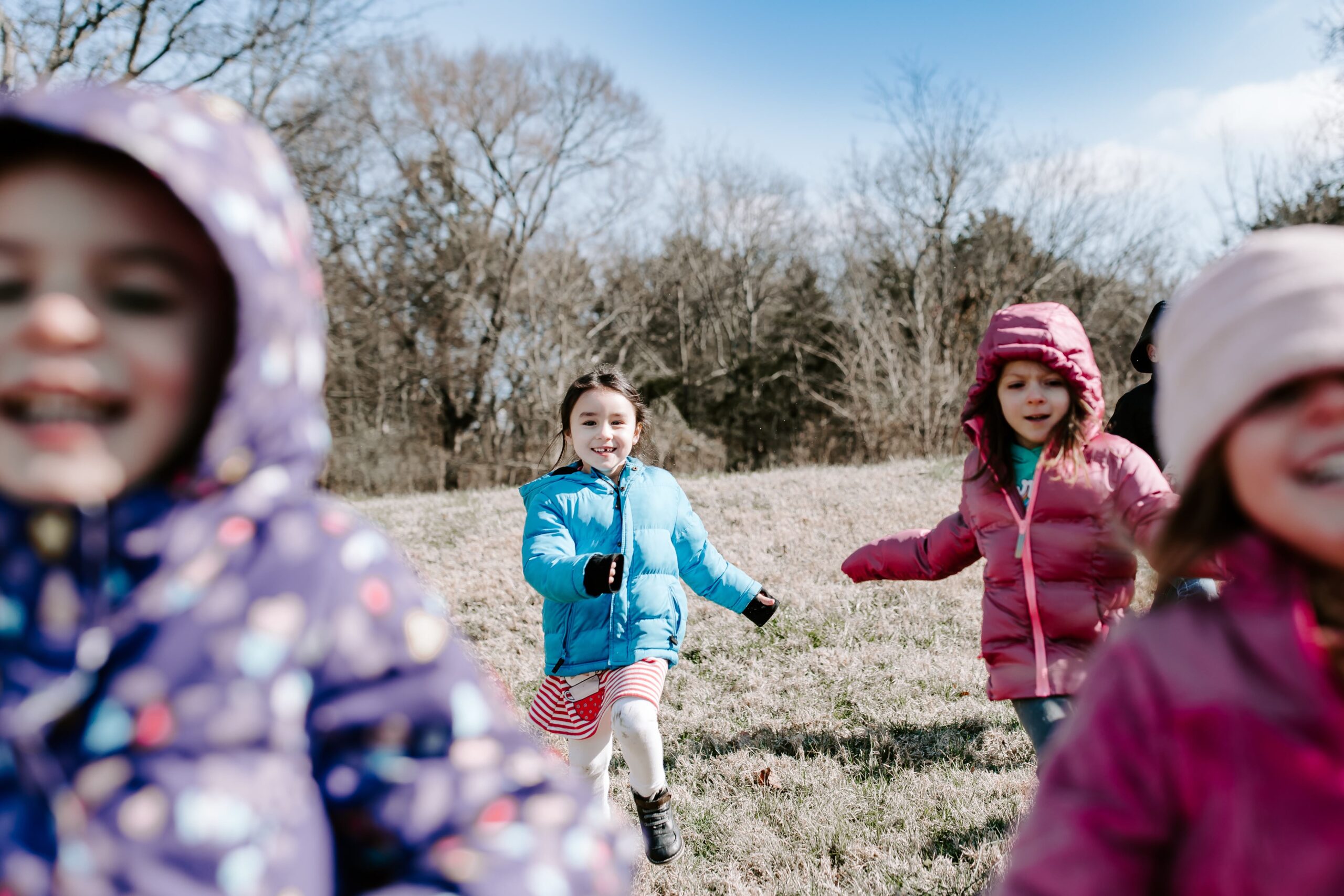A group of preschoolers running outside